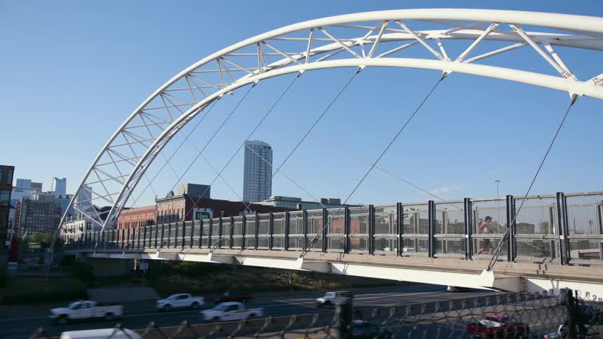 A view of cars driving under a bridge