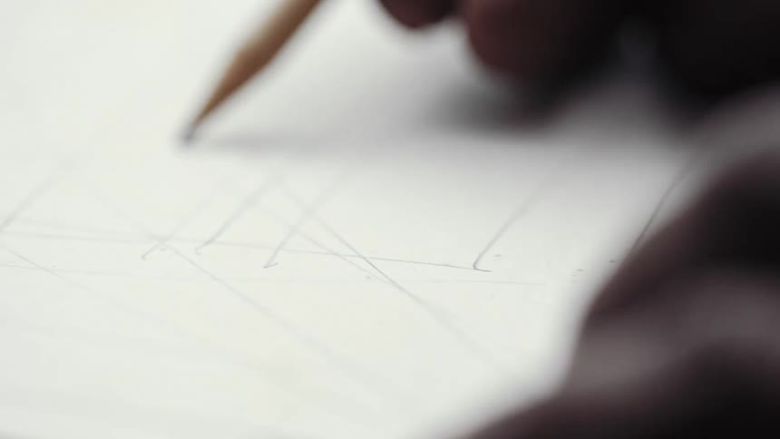 A close up view of a pencil sketching on paper