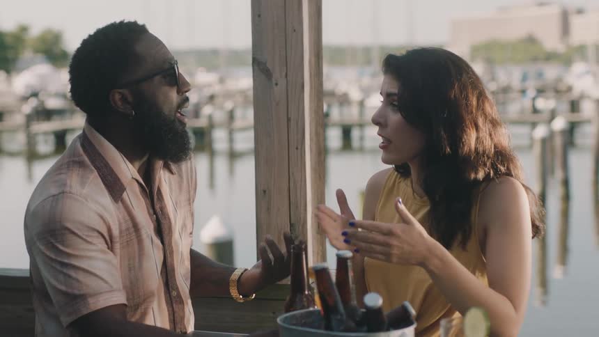 A man and woman talk outside