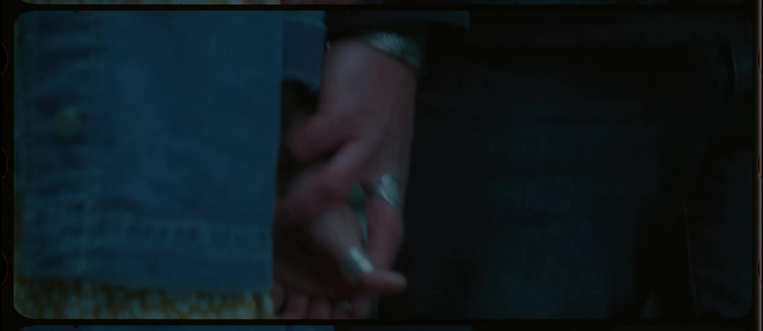 A man trying to grab a womans hand and she pulls away