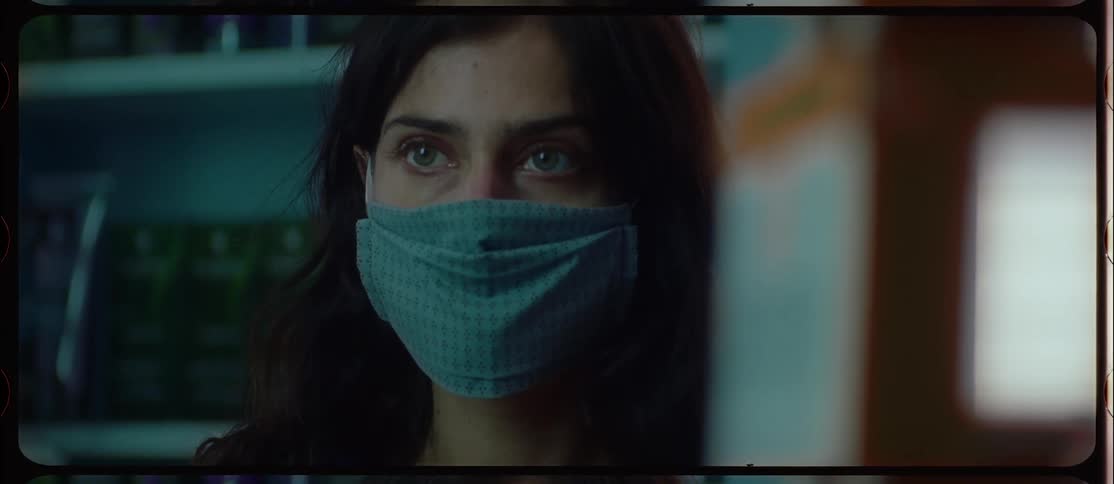 A woman stares nervously then turns to look behind her