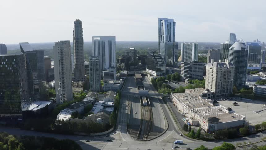 Aerial view of a freeway running through the skyscrapers on the city skyline
