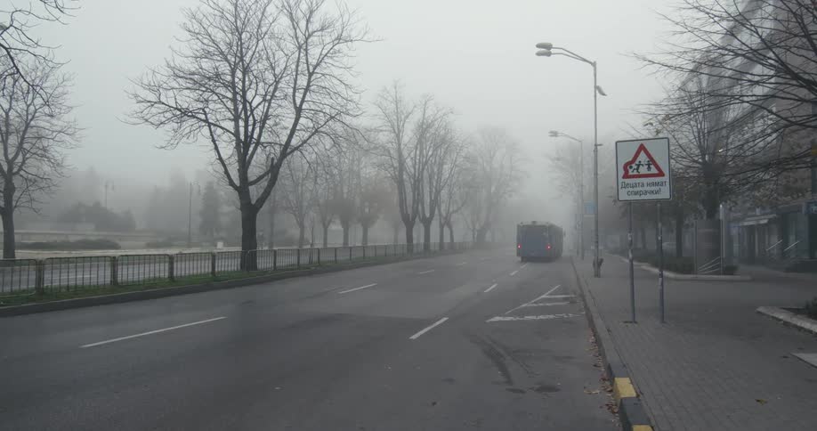 A bus drives down the empty street