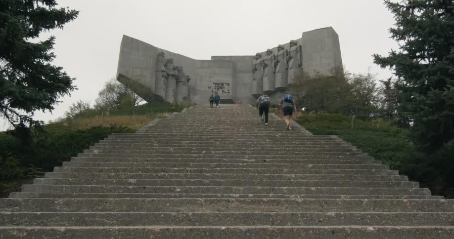 Two people racing up a flight of stairs while running