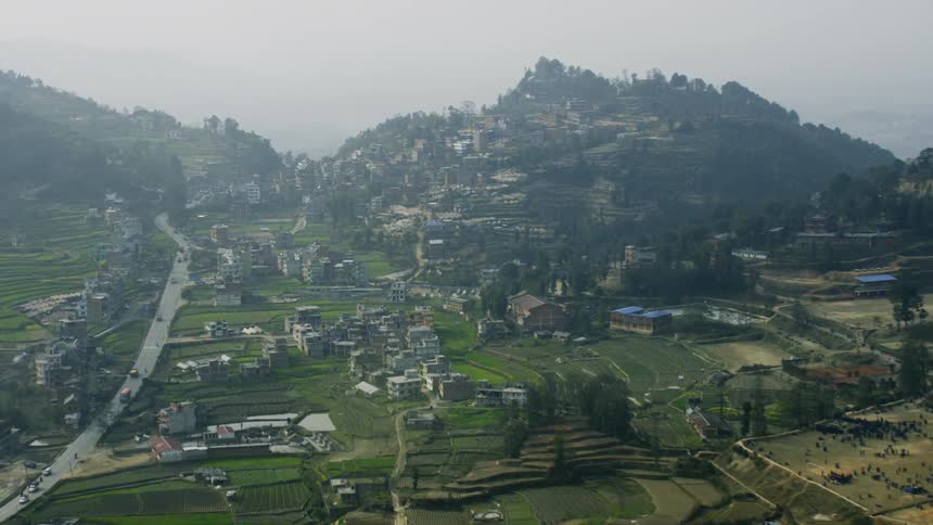 Houses and buildings sparse cover the mountain landscape