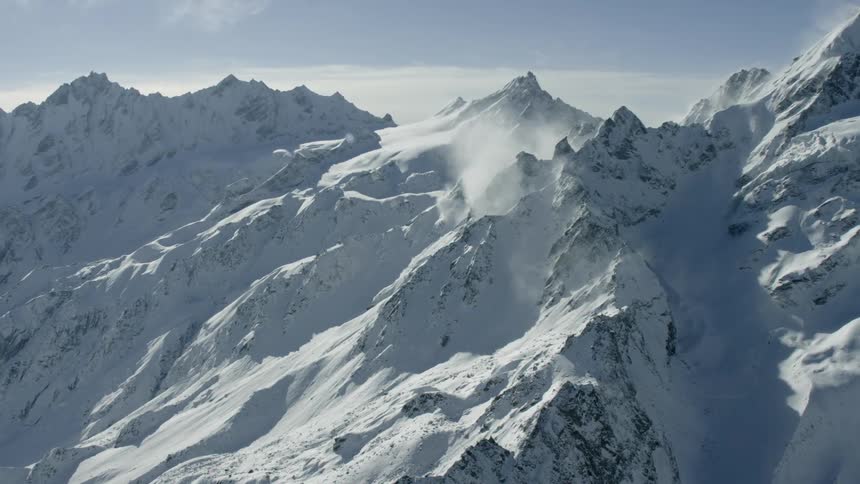 Mist is drifting over mountain peaks on a winter day