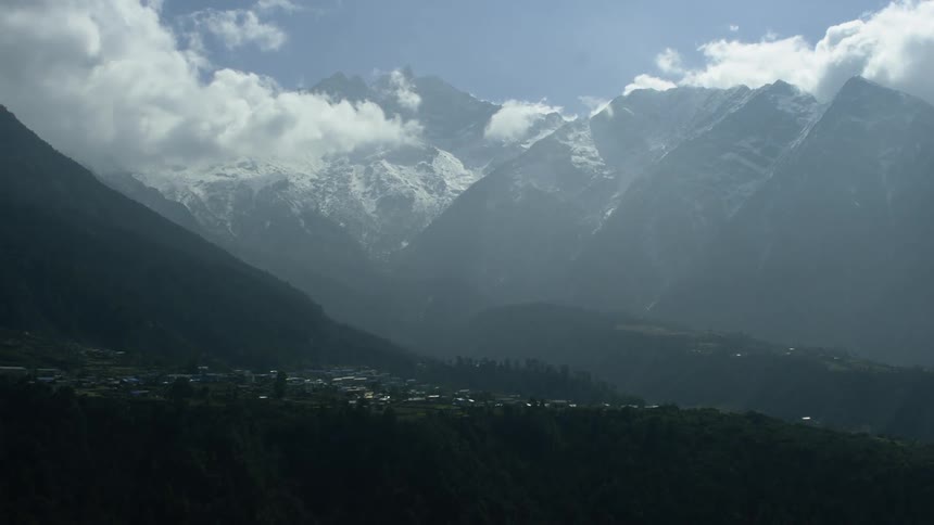 The town ahead is foggy by the mountain