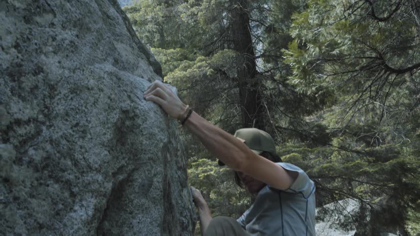 A man begins to rock climb