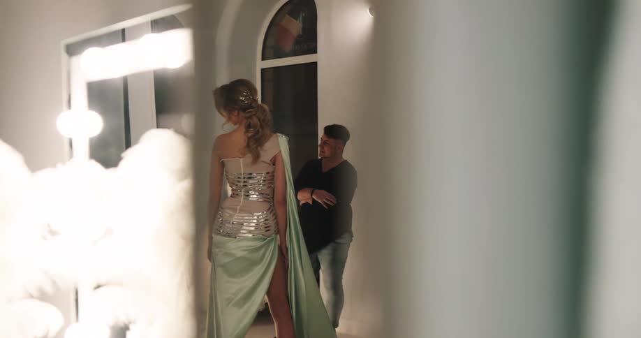 A model dressed in an outfit with silver sequins is posing