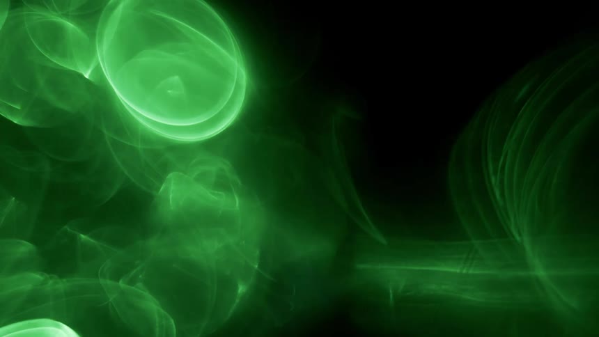Bright glowing green circles and ovals flow and fade against black background