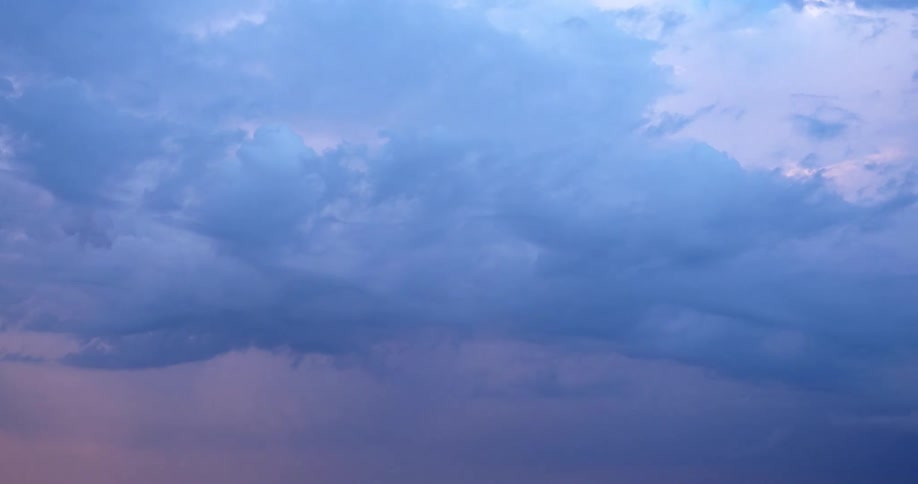 Clouds in shades of blue and purple flow across sky