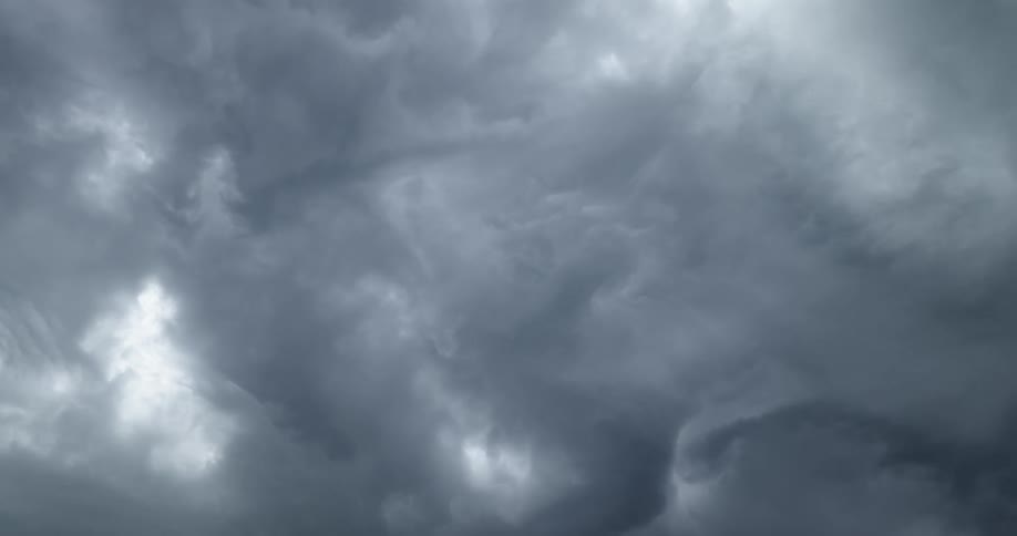 The dark storm clouds move across the sky