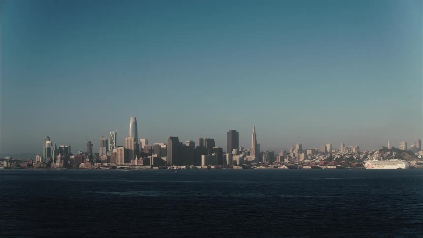 A landscape view of a city skyline on the coast