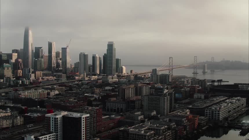 City with tall skyscrapers and a bridge stretching across the water