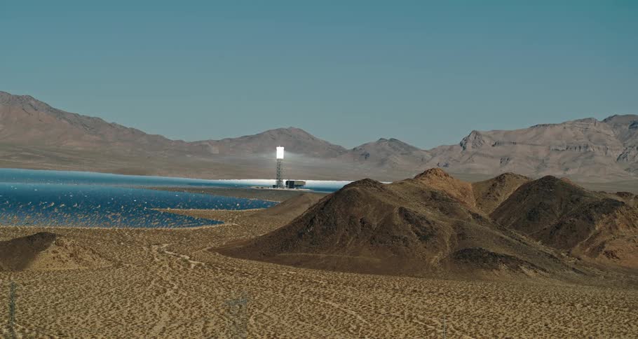 An aerial view of a desert area with a lake