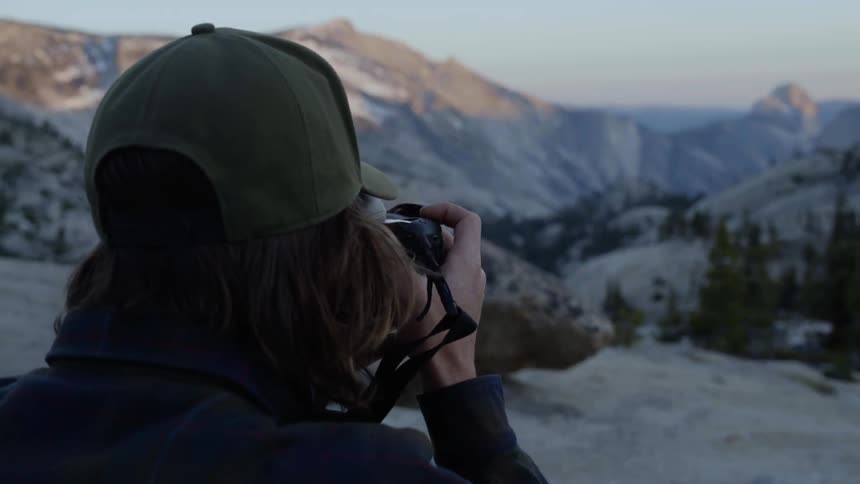 A person is taking photographs on a mountain