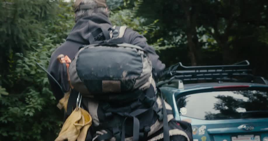 A man is carrying his camping gear to his car