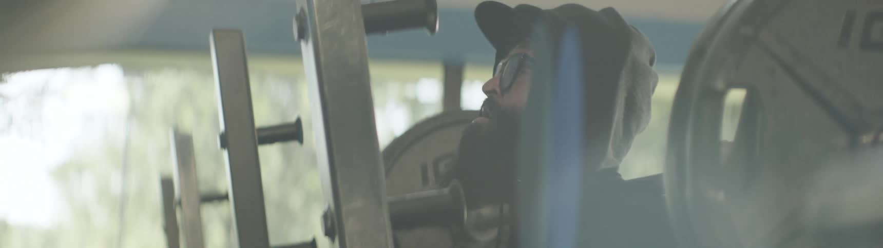 A bearded man weightlifting