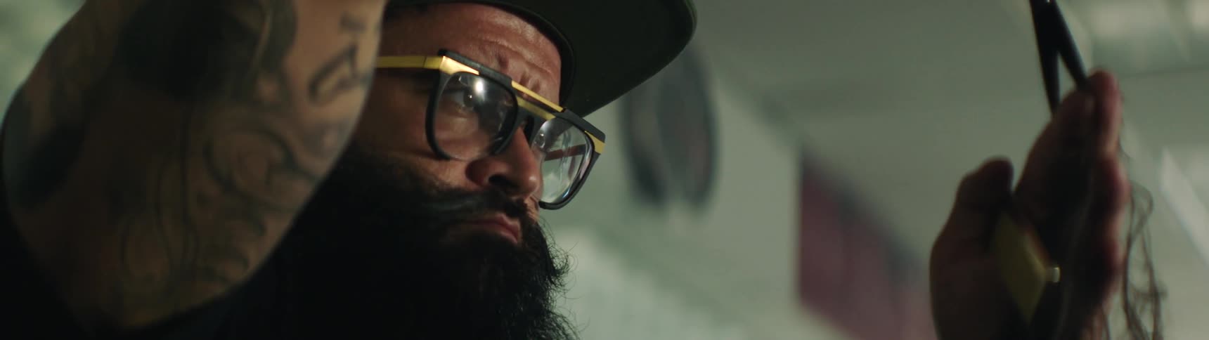 A man with a thick beard works with pliers