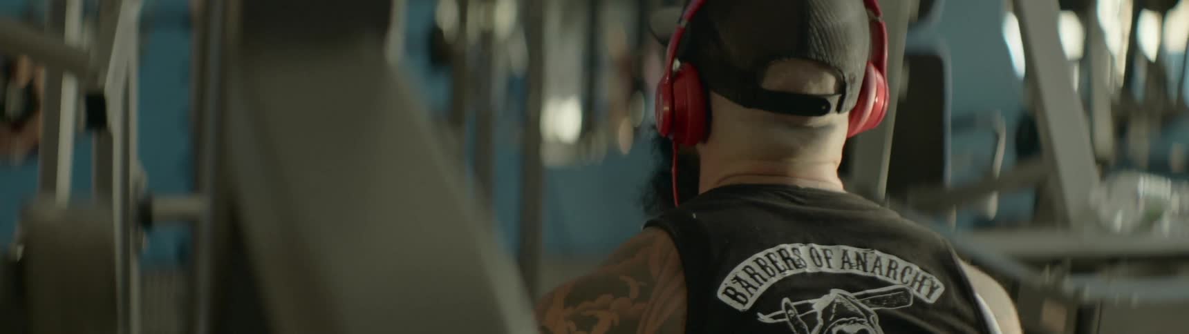 A man wearing headphones shaking his head