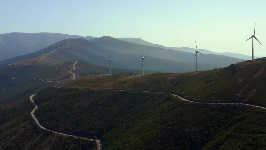 Blades on wind turbines on a hill rotating