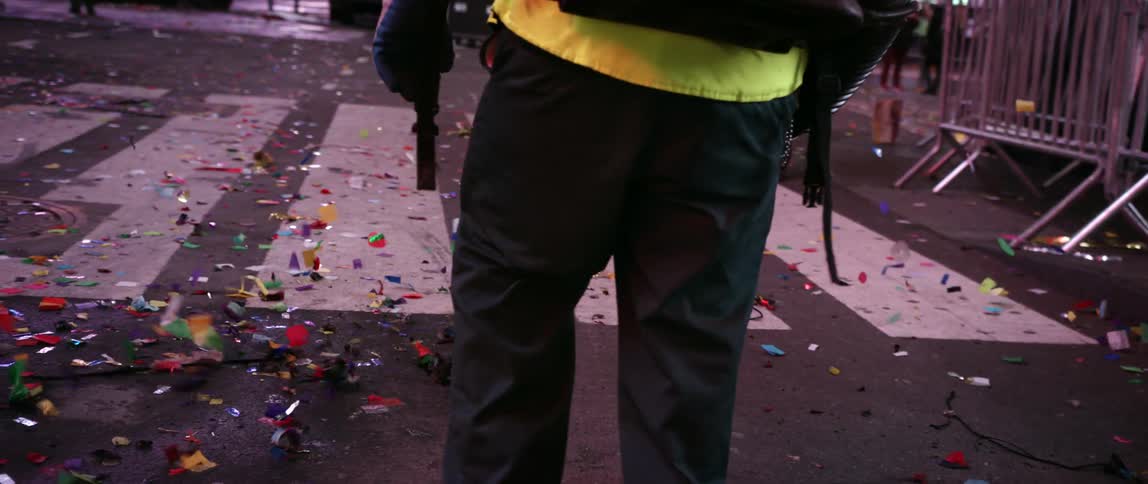 A sanitation worker blows debris with a blower