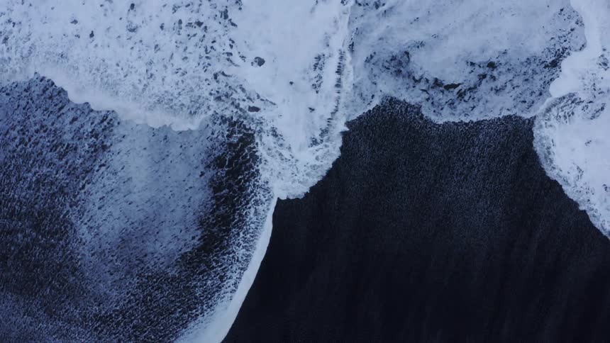 Aerial view of waves rolling in to the shore