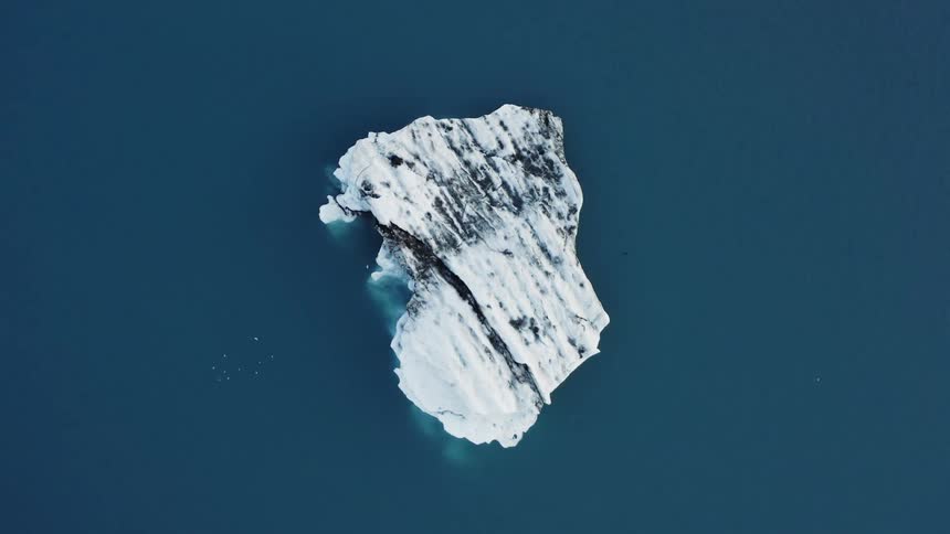 Aerial view of a small iceberg floating on the ocean