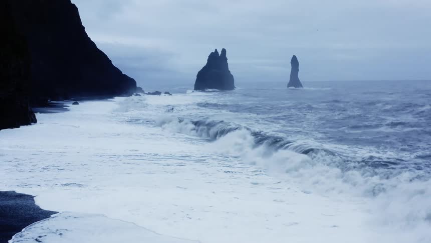 Waves crash against the rocks on the shore
