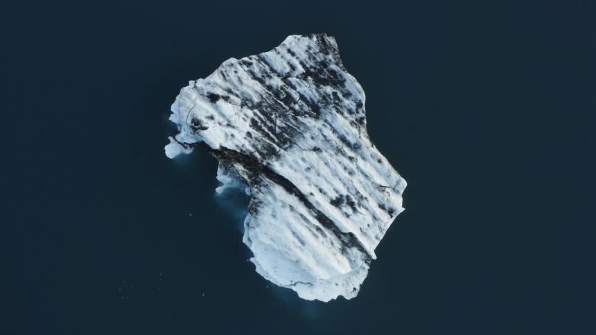 Aerial view of a small iceberg floating on the ocean