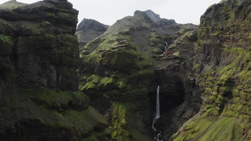 A waterfall cascading down in a mountain range