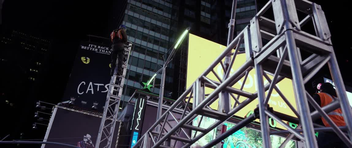 A man climbs up a metal tower