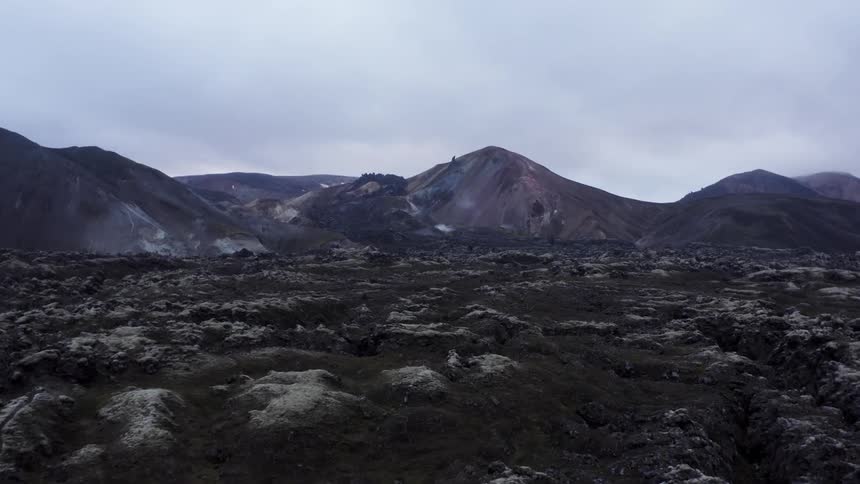 A landscape view of rocky ground in front of a mountain range