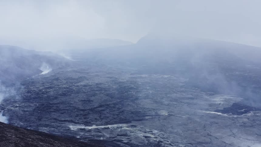 Fog covers ash covered smoking terrain