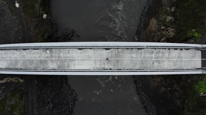 A person running on a bridge over a river