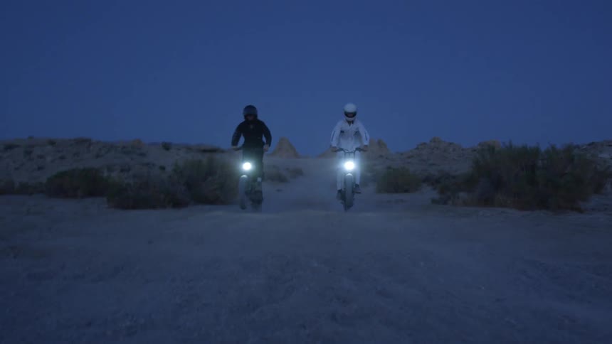 Two people on bikes driving