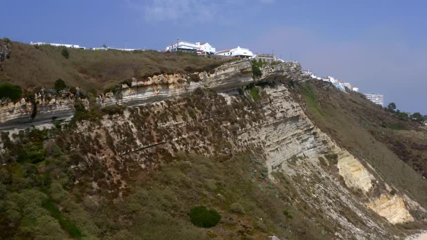 An aerial view of a cliffside at the coast