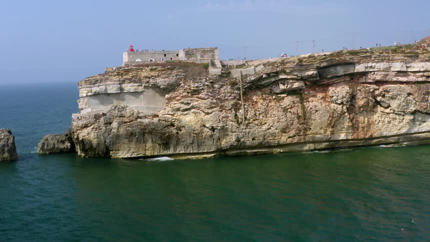 An aerial view of a coast with cliffs