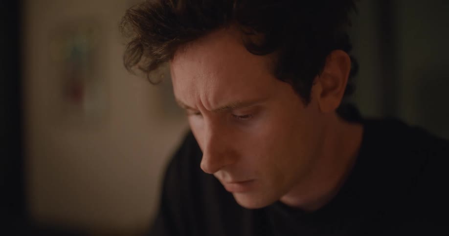 A man takes notes while studying at home