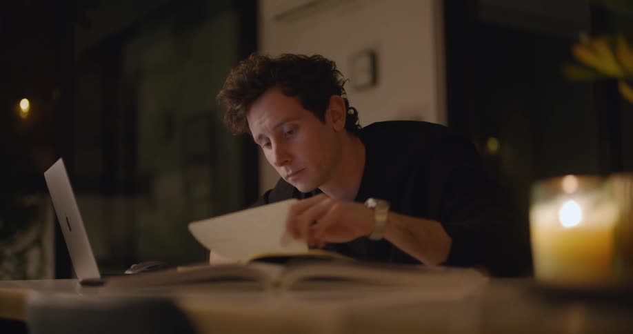A man studying with a computer and books
