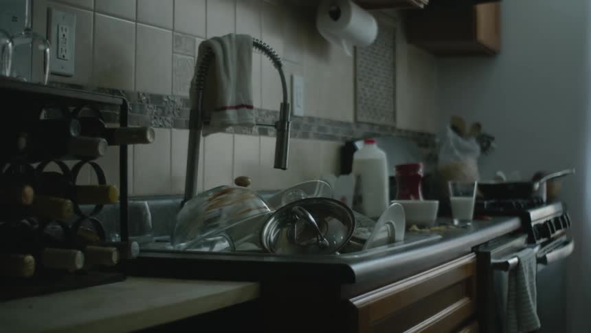 A sink full of dirty dishes in a kitchen