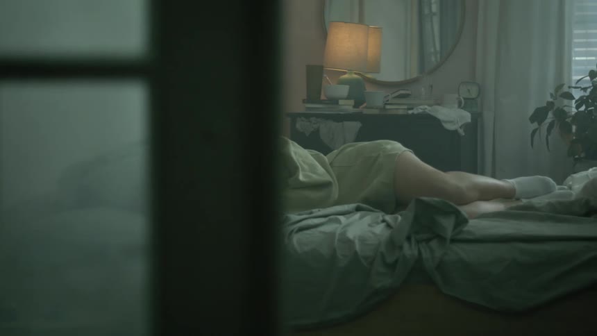 A woman laying in a bed crying