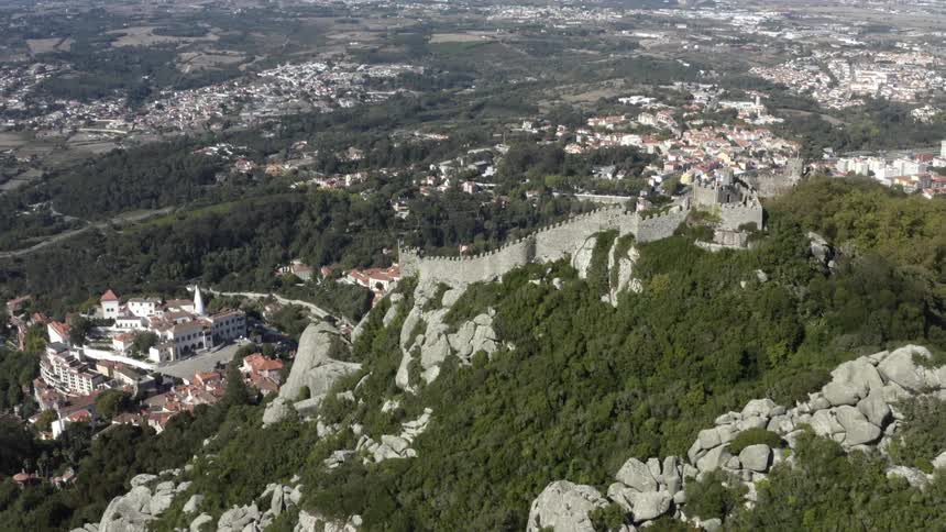 A cliff with a wall rocks and trees