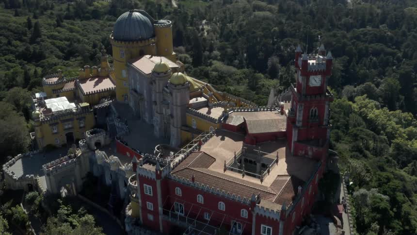 A colorful castle sits on top of a tall hill
