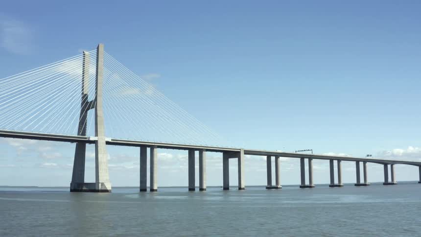 A large bridge spanning a section of ocean on a sunny day