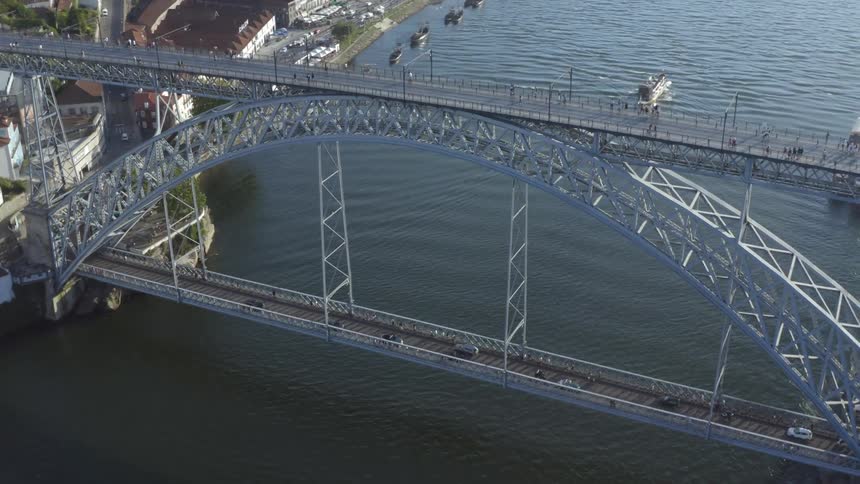 Aerial view of an arched bridge over a river in the city at morning
