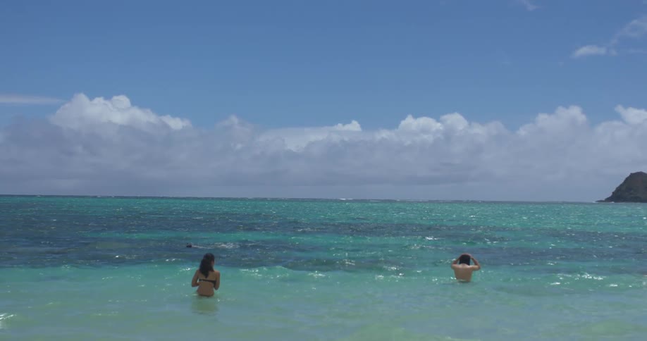 People are walking and swimming in the ocean