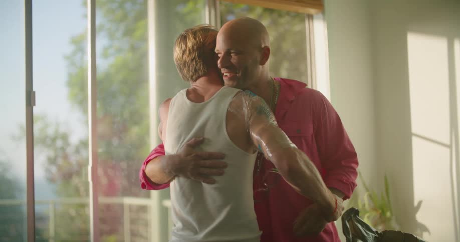 Two men shaking hands and hugging