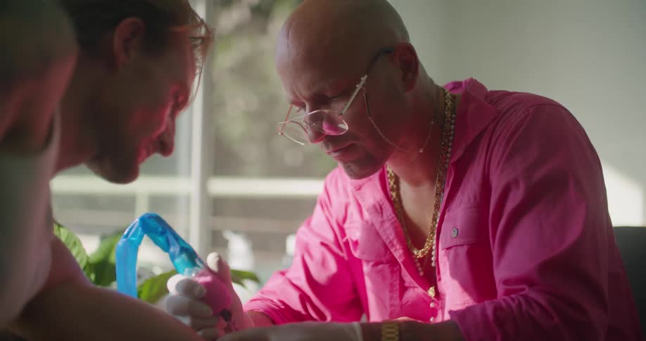A man putting a tattoo onto another man