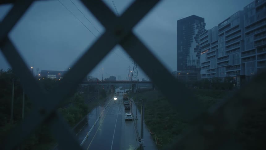 The road is empty by the large buildings